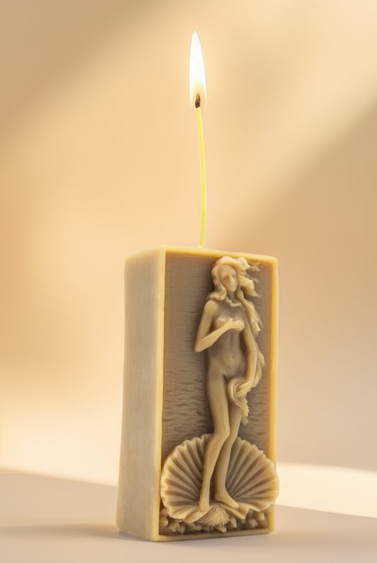 Candle with a figurine design on a neutral background